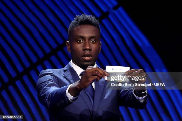 Special guest Blaise Matuidi​​​ pulls out the card of the Netherlands during the UEFA EURO 2024 Final Tournament Draw at Elbphilharmonie on December...