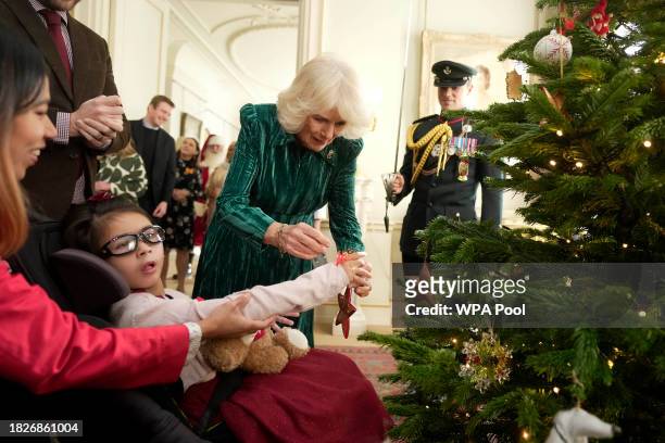 Britain's Queen Camilla and invited children, supported by Helen & Douglas House and Roald Dahl's Marvellous Children's Charity, decorate the...