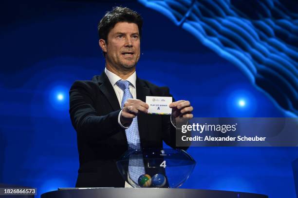 Special guest Brian Laudrup pulls out the card of play-off winner A during the UEFA EURO 2024 Final Tournament Draw at Elbphilharmonie on December...