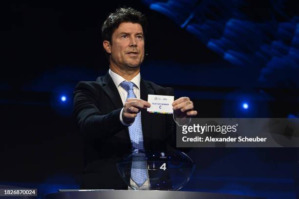 Special guest Brian Laudrup pulls out the card of play-off winner C during the UEFA EURO 2024 Final Tournament Draw at Elbphilharmonie on December...