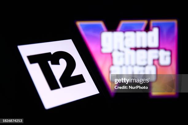 Take-Two Interactive logo displayed on a phone screen and GTA VI logo from the trailer displayed on a laptop screen are seen in this illustration...