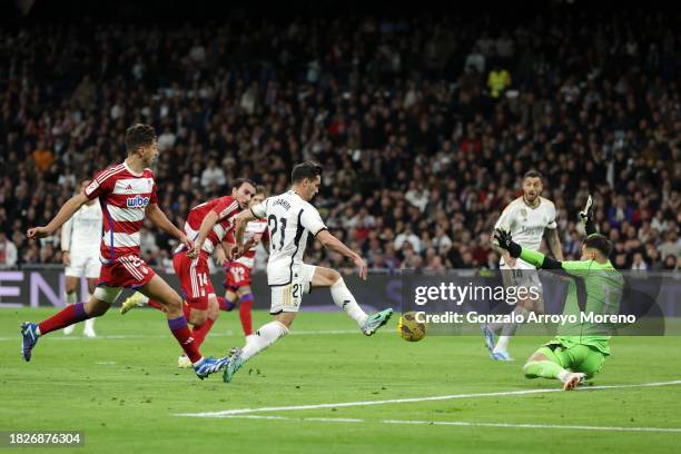 Brahim Diaz of Real Madrid scores the team's first goal during the LaLiga EA Sports match between Real Madrid CF and Granada CF at Estadio Santiago...