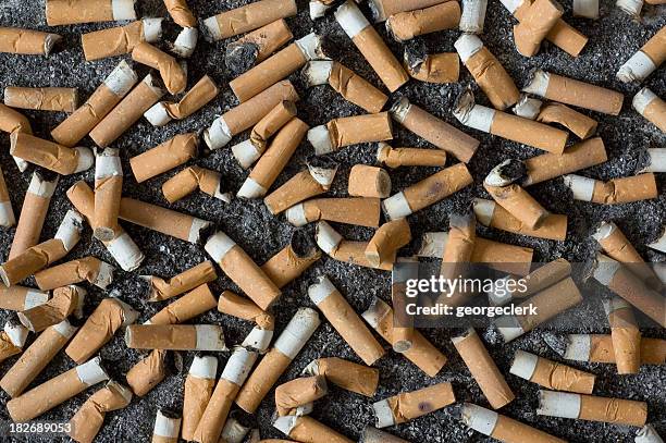 background of cigarette butts and ash - smoking death stock pictures, royalty-free photos & images