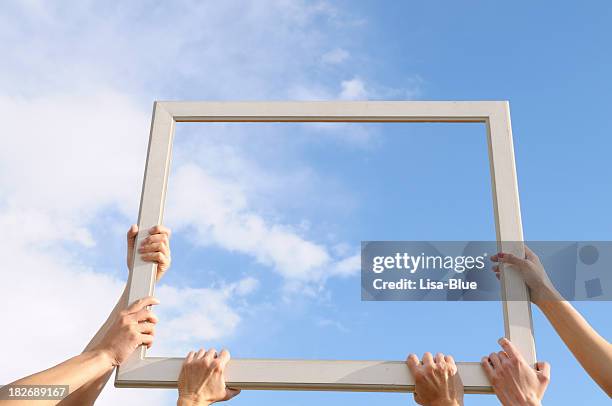 six hands catching clouds blue sky - open sky stockfoto's en -beelden