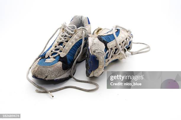 old wornout trainers - old shoes stockfoto's en -beelden