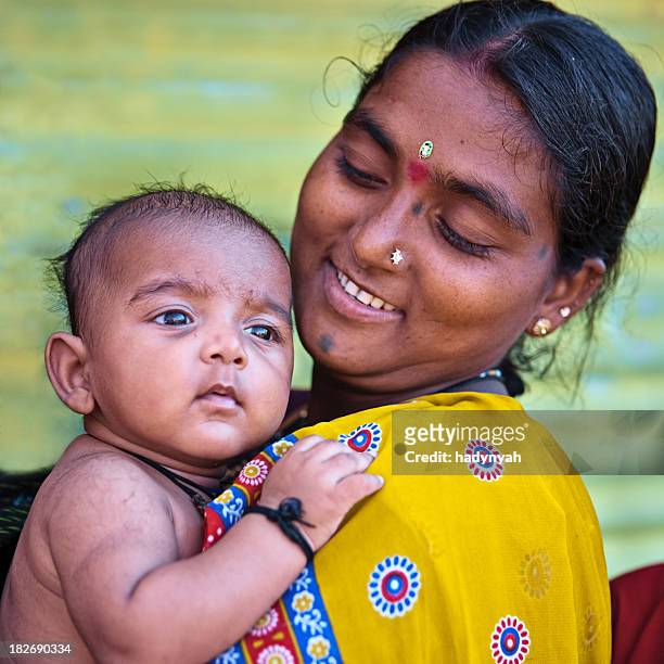 indian woman with her baby - hinduism stockfoto's en -beelden