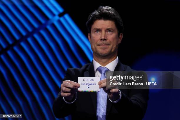 Special guest Brian Laudrup pulls out the card of play-off winner C during the UEFA EURO 2024 Final Tournament Draw at Elbphilharmonie on December...