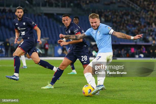 Ciro Immobile of SS Lazio controls the ball whilst under pressure from Gabriele Zappa of Cagliari Calcio during the Serie A TIM match between SS...