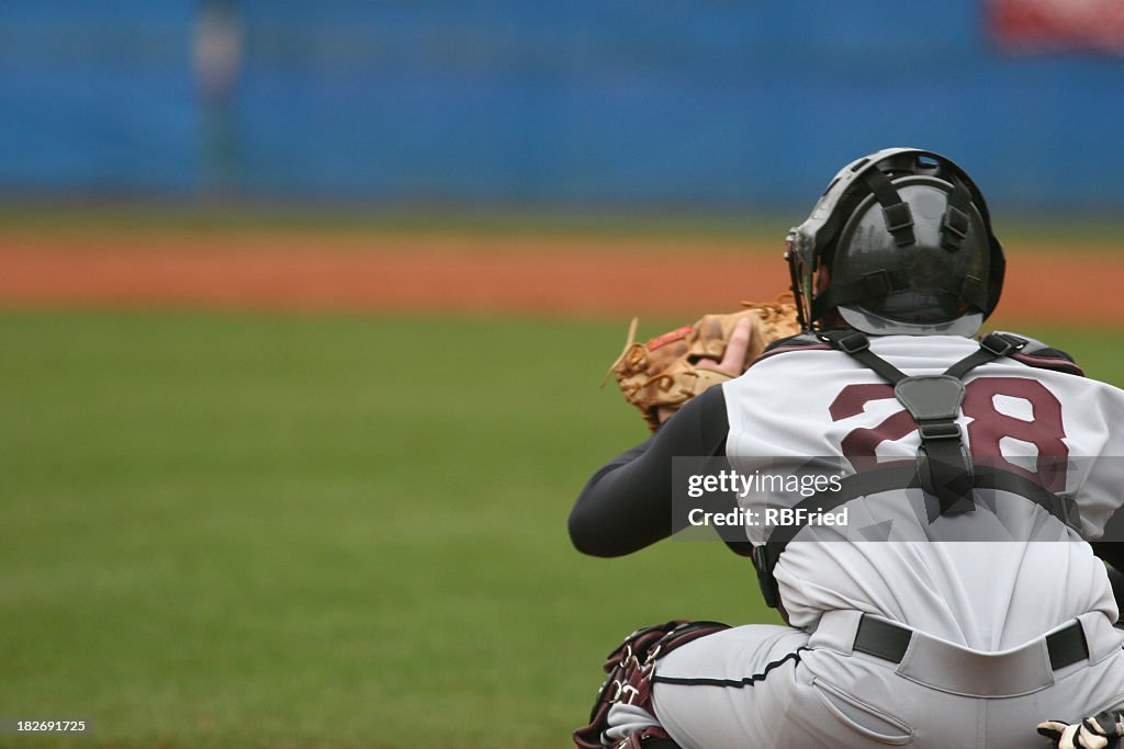 Catcher at a baseball game in position to catch