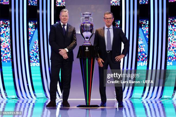 Ronald Koeman, Head Coach of the Netherlands, and Ralf Rangnick, Head Coach of Austria, pose for a photo with the UEFA EURO 2024 trophy after being...