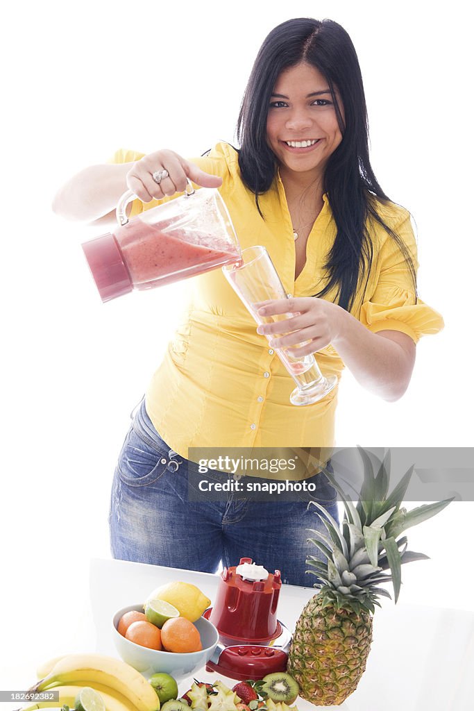 Healthy Young Woman Making a Fruit Smoothie