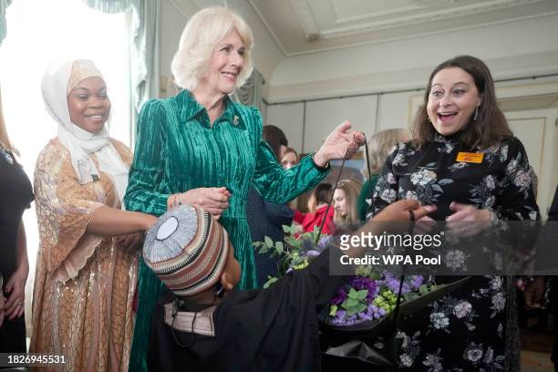 Britain's Queen Camilla invites children, supported by Helen & Douglas House and Roald Dahl's Marvellous Children's Charity, to decorate the...