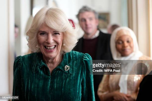 Britain's Queen Camilla arrives with invited children, supported by Helen & Douglas House and Roald Dahl's Marvellous Children's Charity, to decorate...