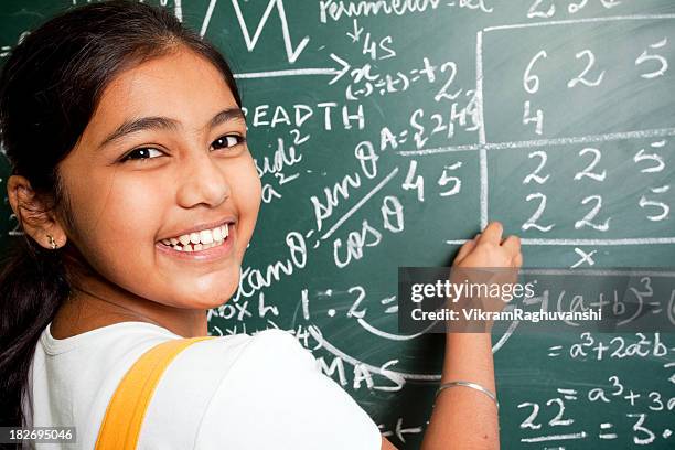 cheerful indian girl student with mathematics problems - indian girl pointing stock pictures, royalty-free photos & images