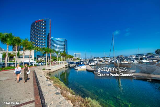 tourists, streets and buildings along seaport village and embarcadero park - san francisco financial district stock pictures, royalty-free photos & images
