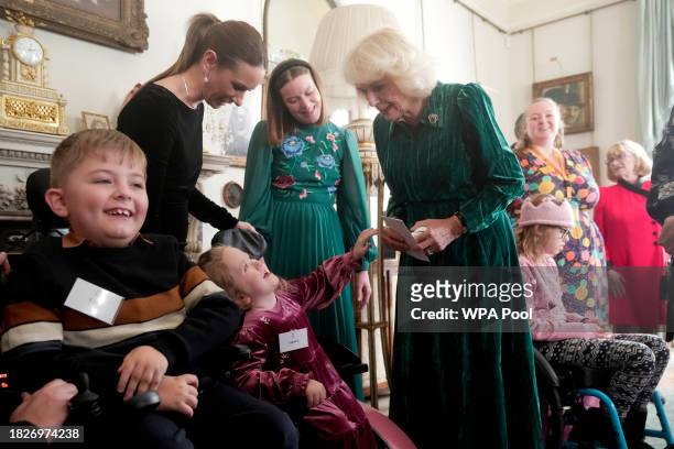 Britain's Queen Camilla welcomes invited children, supported by Helen & Douglas House and Roald Dahl's Marvellous Children's Charity, to decorate the...