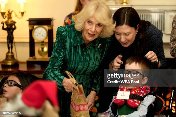 Britain's Queen Camilla welcomes invited children, supported by Helen & Douglas House and Roald Dahl's Marvellous Children's Charity, to decorate the...