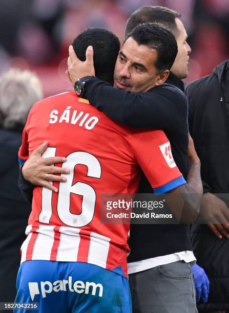 Head coach Miguel Sanchez 'Michel' of Girona FC hugs Savinho Moreira during the LaLiga EA Sports match between Girona FC and Valencia CF at Montilivi...