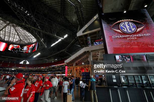 Fans enter the stadium prior to the SEC Championship game between the Alabama Crimson Tide and the Georgia Bulldogs at Mercedes-Benz Stadium on...