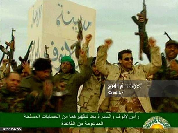 An image grab taken from Libya's state television on March 11, 2011 shows Libyan leader Moamer Kadhafi's forces celebrating after driving back...