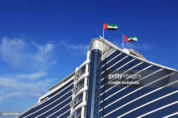 uae flags on building - united arab emirates flag stock pictures, royalty-free photos & images