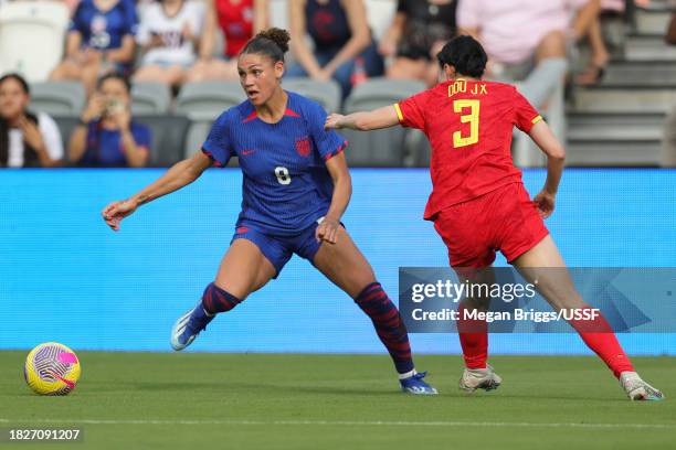 Trinity Rodman of the United States is marked by Dou Jiaxing of China PR during the first half of an international friendly at DRV PNK Stadium on...