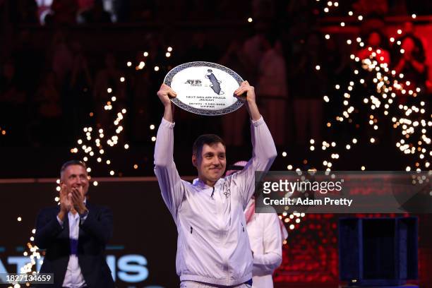 Hamad Medjedovic of Serbia lifts the Next Gen ATP Finals Trophy after winning the final against Arthur Fils of France during day five of the Next Gen...