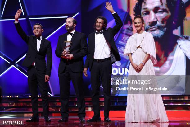 Ayoub Elaid, director Kamal Lazraq, Abdellatif Masstouri, winners of the Jury Prize for the movie "Hounds" , and Leïla Slimani stand on stage during...