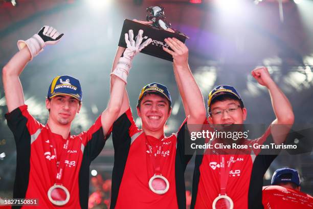 Race winners Mateo Estevez , Mehdi Hafidi and Ryota Kokubun of Nissan celebrate on the podium with the Manufacturers Cup trophy after the...