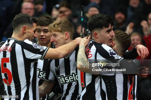 Anthony Gordon of Newcastle United celebrates with teammate Fabian Schaer after scoring the team's first goal during the Premier League match between...