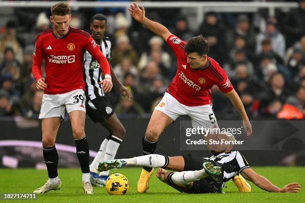 Harry Maguire of Manchester United clashes with Joelinton of Newcastle United during the Premier League match between Newcastle United and Manchester...