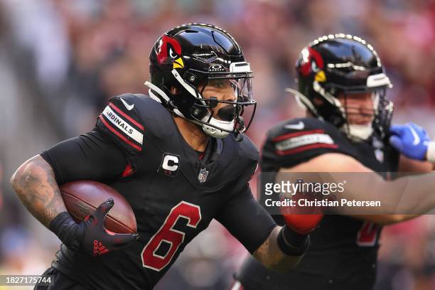 Running back James Conner of the Arizona Cardinals rushes the football during the NFL game at State Farm Stadium on November 26, 2023 in Glendale,...