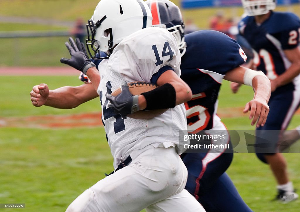 Football players running with the ball