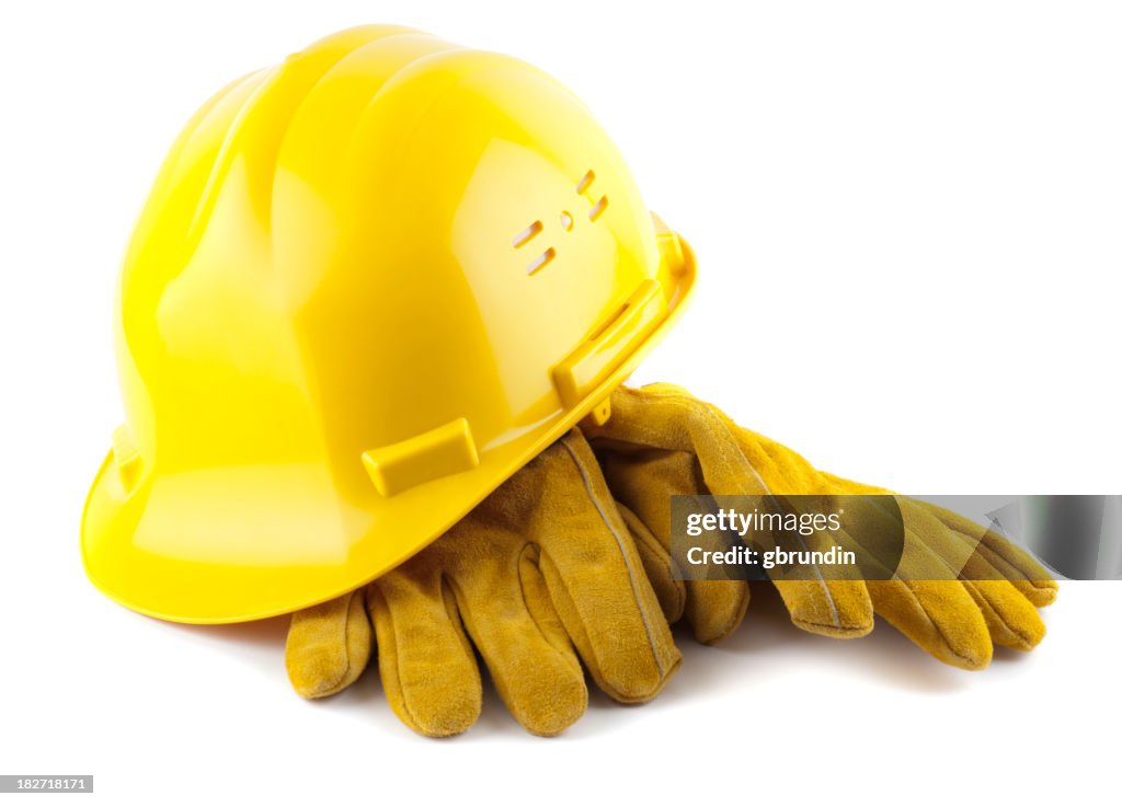 Yellow construction helmet and gloves isolated on white