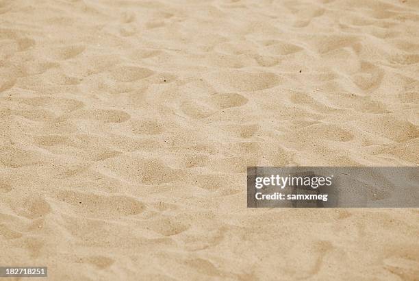 a close-up of sand on a beach with numerous footprints - sand textured textured effect stock pictures, royalty-free photos & images