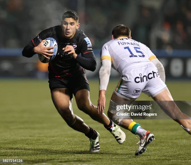 Lucio Cinti of Saracens takes on George Furbank during the Gallagher Premiership Rugby match between Saracens and Northampton Saints at the StoneX...