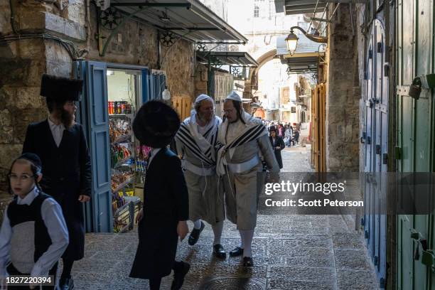 Ultra-Orthodox Jews walk along a warren of shops as Israeli Jews and Palestinians live daily lives, in the ancient walled Old City of Jerusalem,...