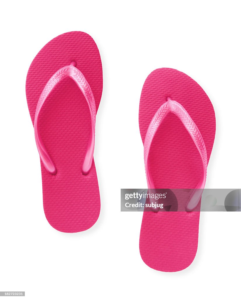 Close-up of a pair of pink flip flops isolated on white