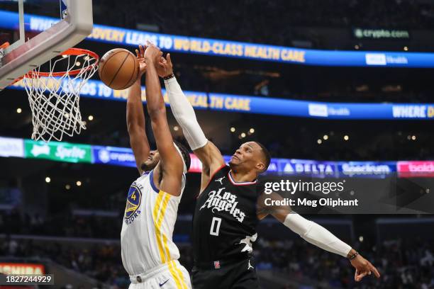 Russell Westbrook of the LA Clippers blocks a shot by Moses Moody of the Golden State Warriors in the second quarter at Crypto.com Arena on December...