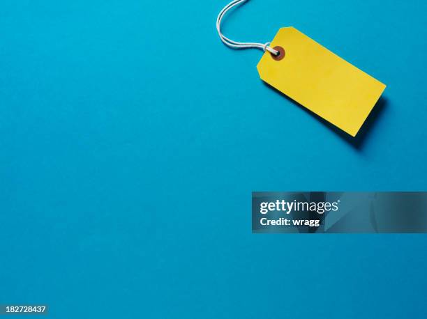 yellow label on a blue background - labelling stock pictures, royalty-free photos & images