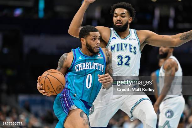 Miles Bridges of the Charlotte Hornets attempts to drive past Karl-Anthony Towns of the Minnesota Timberwolves during the first half of their game at...