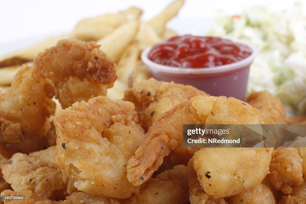 Fried breaded shrimp with fries and ketchup dip