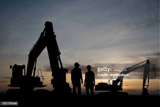 excavators at dawn - engaged sunset stockfoto's en -beelden