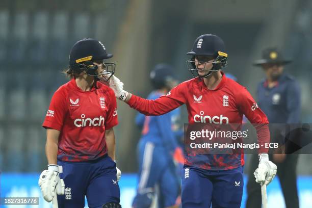 Amy Jones of England and Freya Kemp of England interact during the 1st T20 International match between India Women and England Women at Wankhede...