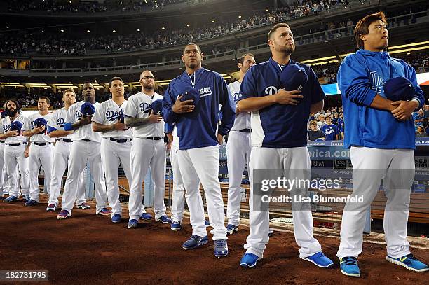 The Los Angeles Dodgers stands during the national anthem before the game against the Colorado Rockies at Dodger Stadium on September 27, 2013 in Los...