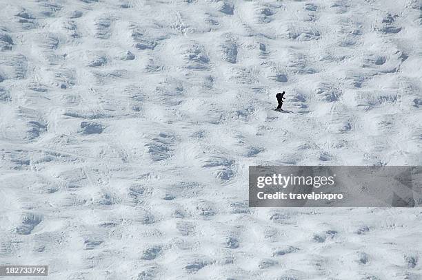 ski slope lone skier - mogul skiing stockfoto's en -beelden