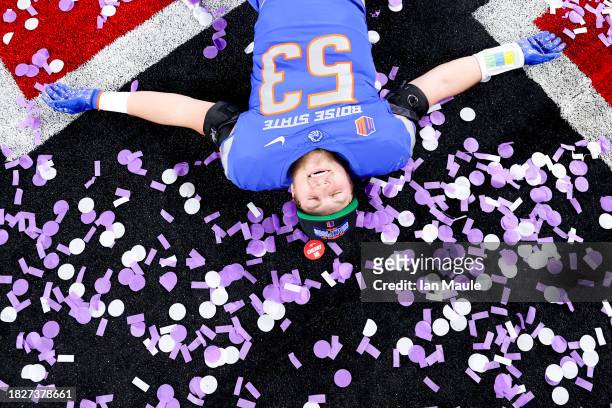 Marco Notarainni of the Boise State Broncos lays in confetti after his team's 44-20 win against the UNLV Rebels during the Mountain West Football...