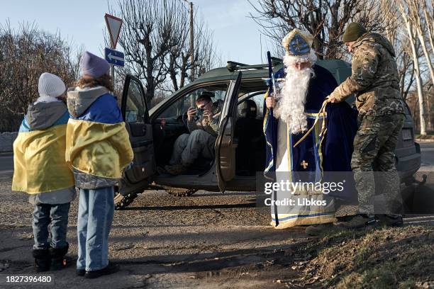 Soldier from the "Edelweiss" brigade gives out gifts to children in the community on December 6, 2023 on December 6, 2023 in Druzhkivka, Ukraine. The...