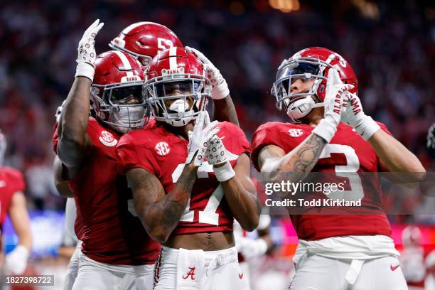 Isaiah Bond, Jermaine Burton and Roydell Williams of the Alabama Crimson Tide react after a catch during the fourth quarter against the Georgia...