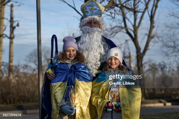 Soldier from the "Edelweiss" brigade poses with local children after giving out gifts to the community on December 6, 2023 on December 6, 2023 in...